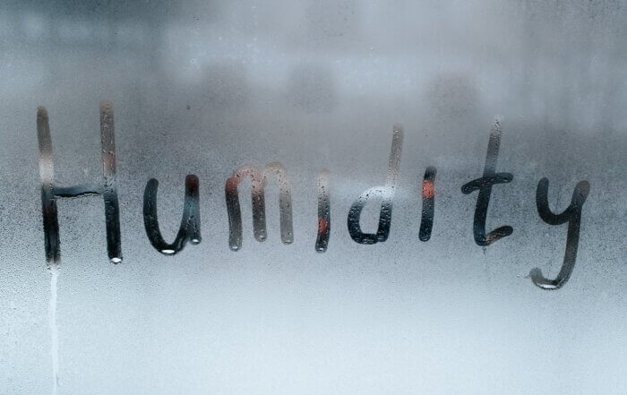 Word Humidity written on misted wet window glass. Concept weather, climate, meteorology