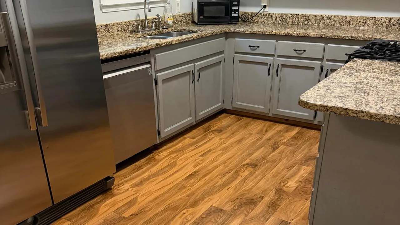Kitchen with granite counters and pale cabinets after a cleaning visit
