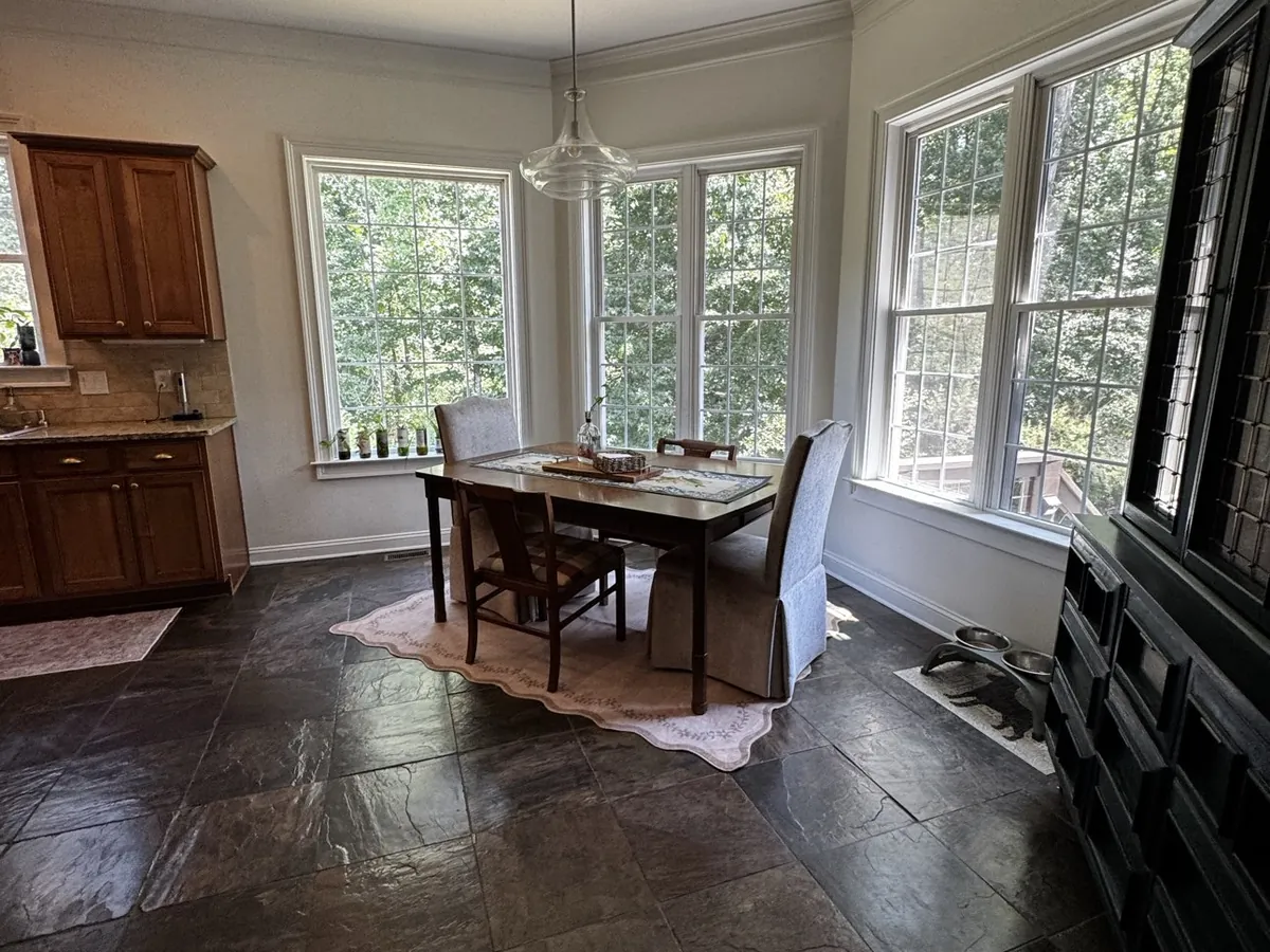 Bay-window dining area with dark hardwood floors in a Metro Atlanta home after a cleaning visit